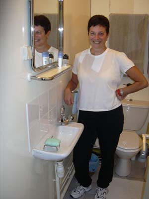 Susan shows off the sink in one of her bathrooms