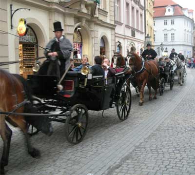 A horse-drawn procession ambles by our cafe