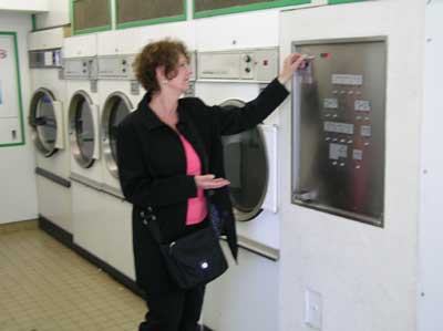 Carol at the laundromat in Bayeaux