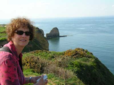 Carol looking at the tall cliffs that our Rangers had to scale at Pont du Hoc