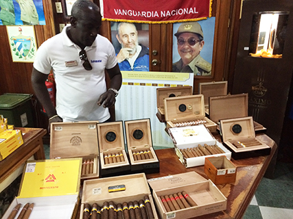 Ramiro contemplates the cigars at the Romeo y Julieta store in Havana