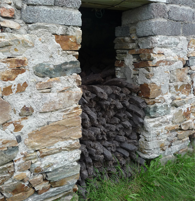 Peat being stored in a stone shed