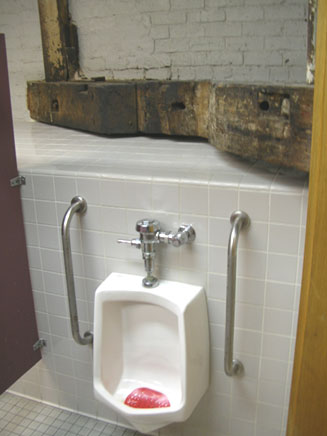 Old wooden beam in the men's room at the Lafitte House