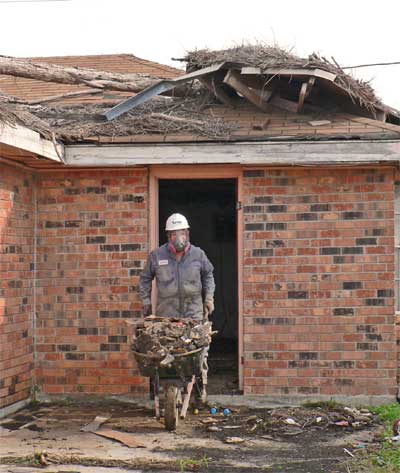 On the job - notice the storm debris still on the roof, 16 months afterwards.