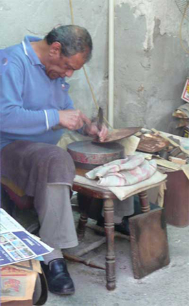 Craftsman at work in a market in Old Acco