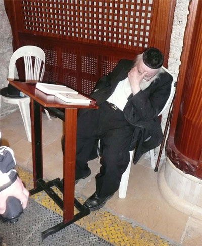 Praying (resting?) at the Western Wall