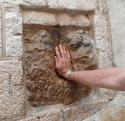 My hand where Jesus touched this wall along the Via Dolorosa