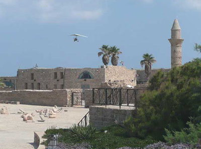 An ultralight plane flying over the ruins at Caesarea