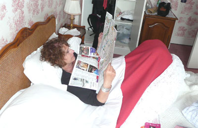 Carol resting at Le Hotel des Grande Ecoles, studying the map for more adventures in Paris