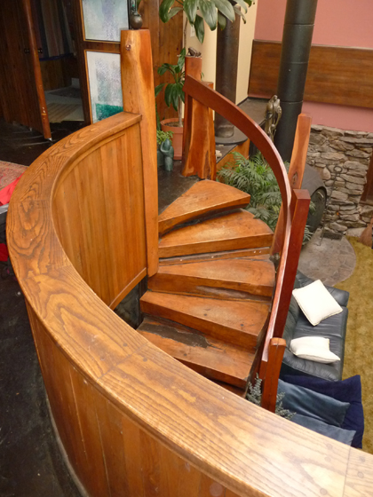 Beautiful hand-crafted wooden spiral staircase descending to a lower level at Bruce Fink's House Of Magic on Pole Bridge Road in Woodstock, Connecticut