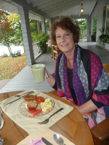 Carol enjoys a delicious breakfast, prepared by Aaron’s father, of banana-orange smoothie, coffee, Greek eggs (spinach, feta, tomato) raisin toast and blueberry muffin, at the Buffelhead Cove B&B in Kennebunkport, Maine