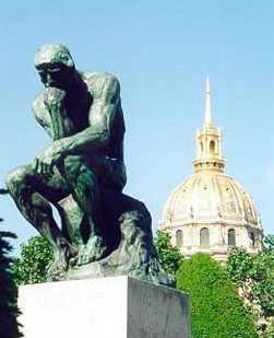 Rodin's The Thinker with the dome of Les Invalides in the background
